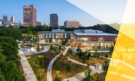 Photo of three people with campus background