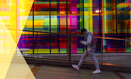 Photo of three people with campus background