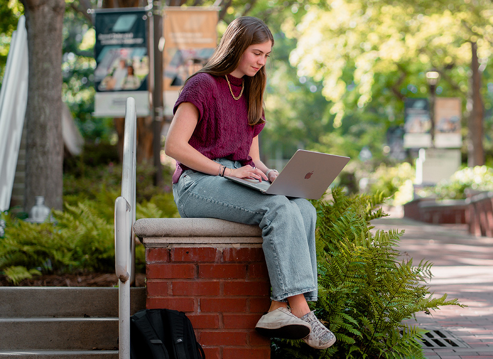 Student using computer on Georgia Tech campus