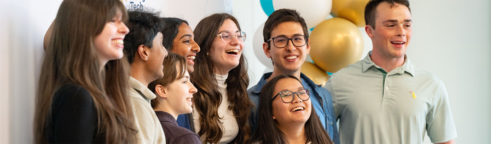 students standing happily on a stage