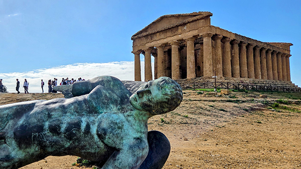 View of the Parthenon with a statue in the foreground