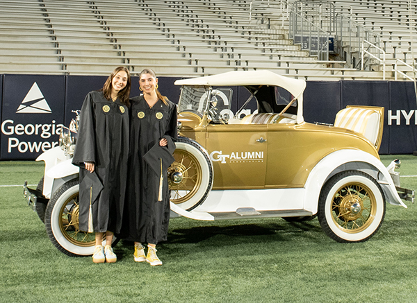 Two graduating students posing with Wreck