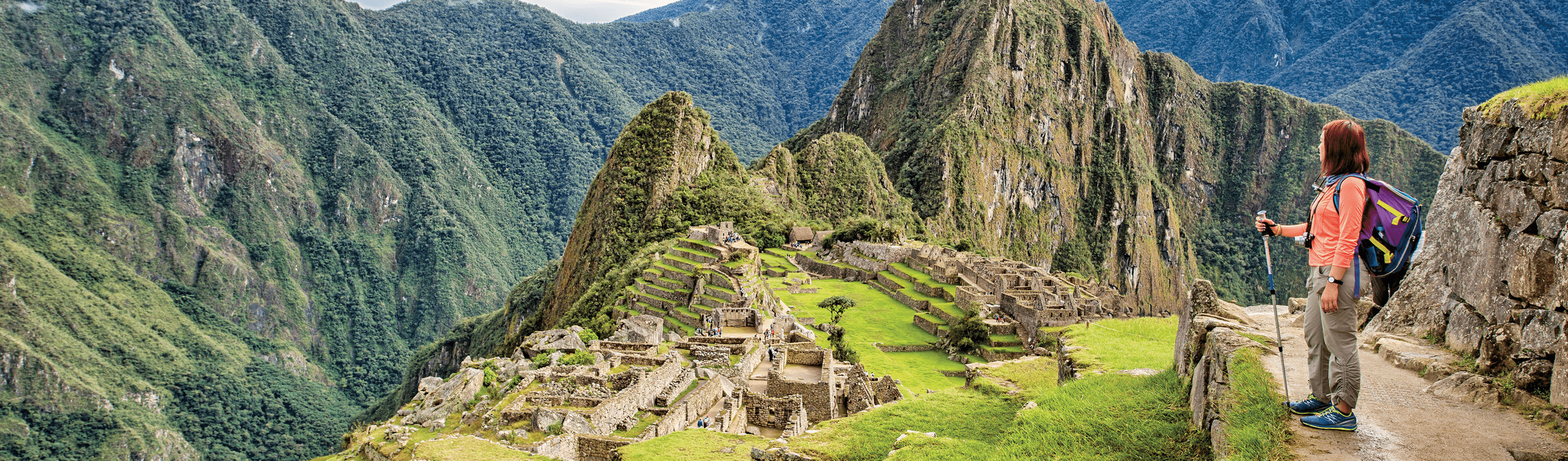 Woman standing and looking at Machu Picchu