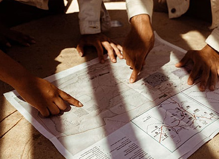 Hands pointing to a map