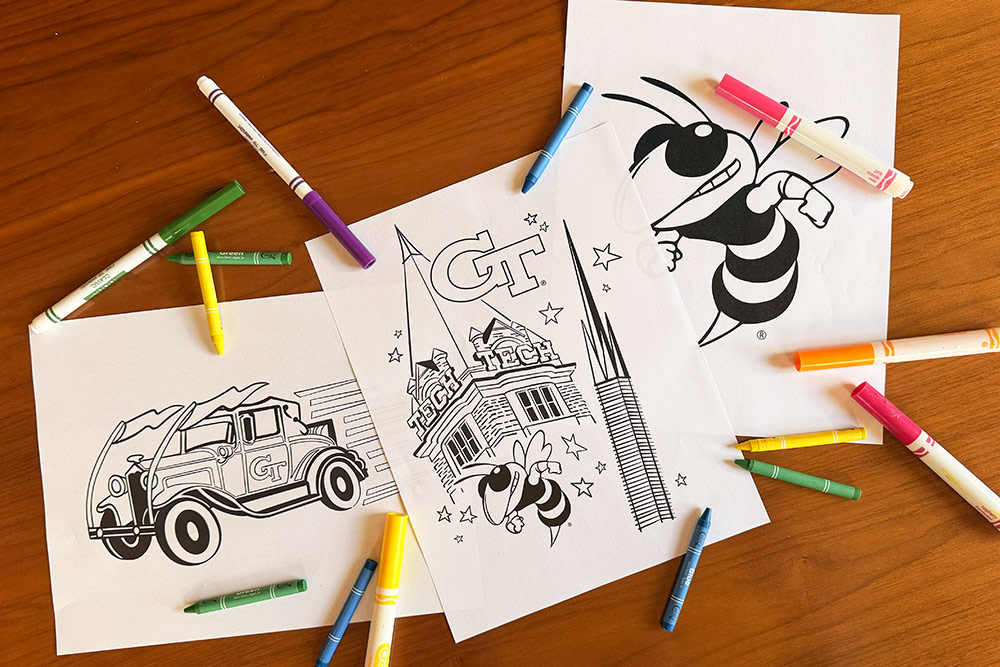 Three GT Coloring sheets on table, featuring Buzz and Tech Tower