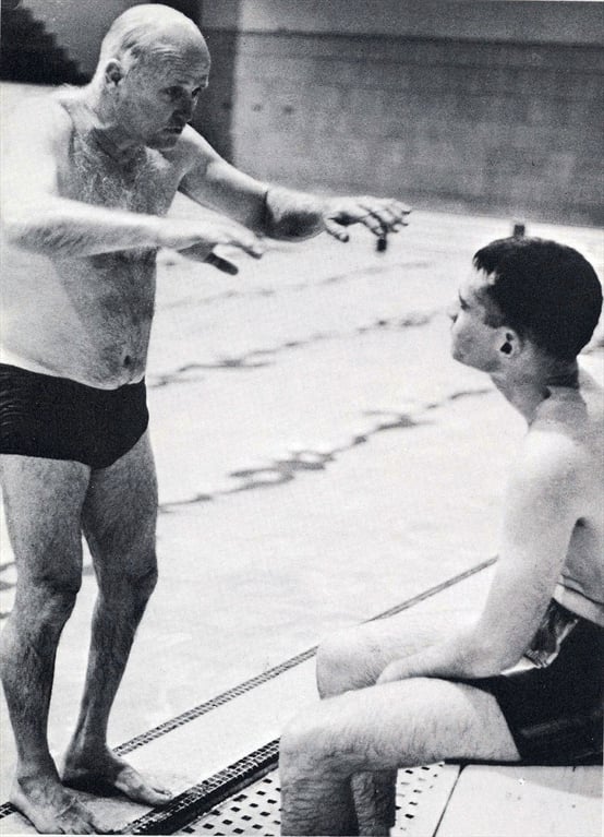 man teaching a student how to swim