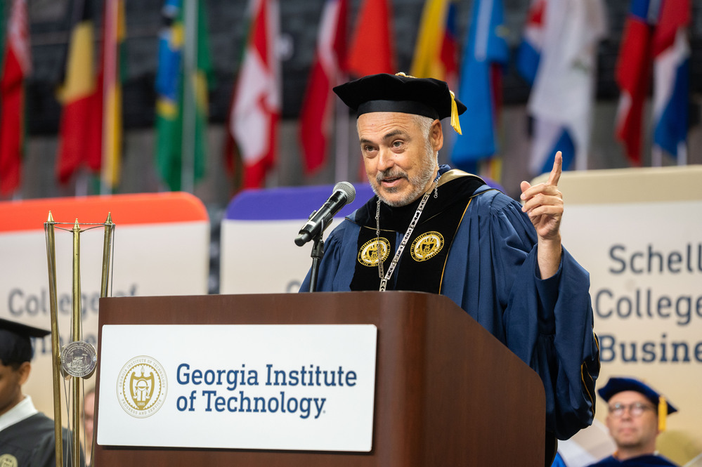 Cabrera speaking at commencement in front of a podium. 