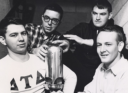 four students holding the whistle