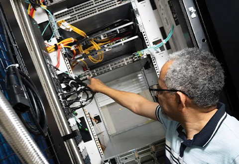 a person looking at a computer drive in the artificial intelligence makerspace.