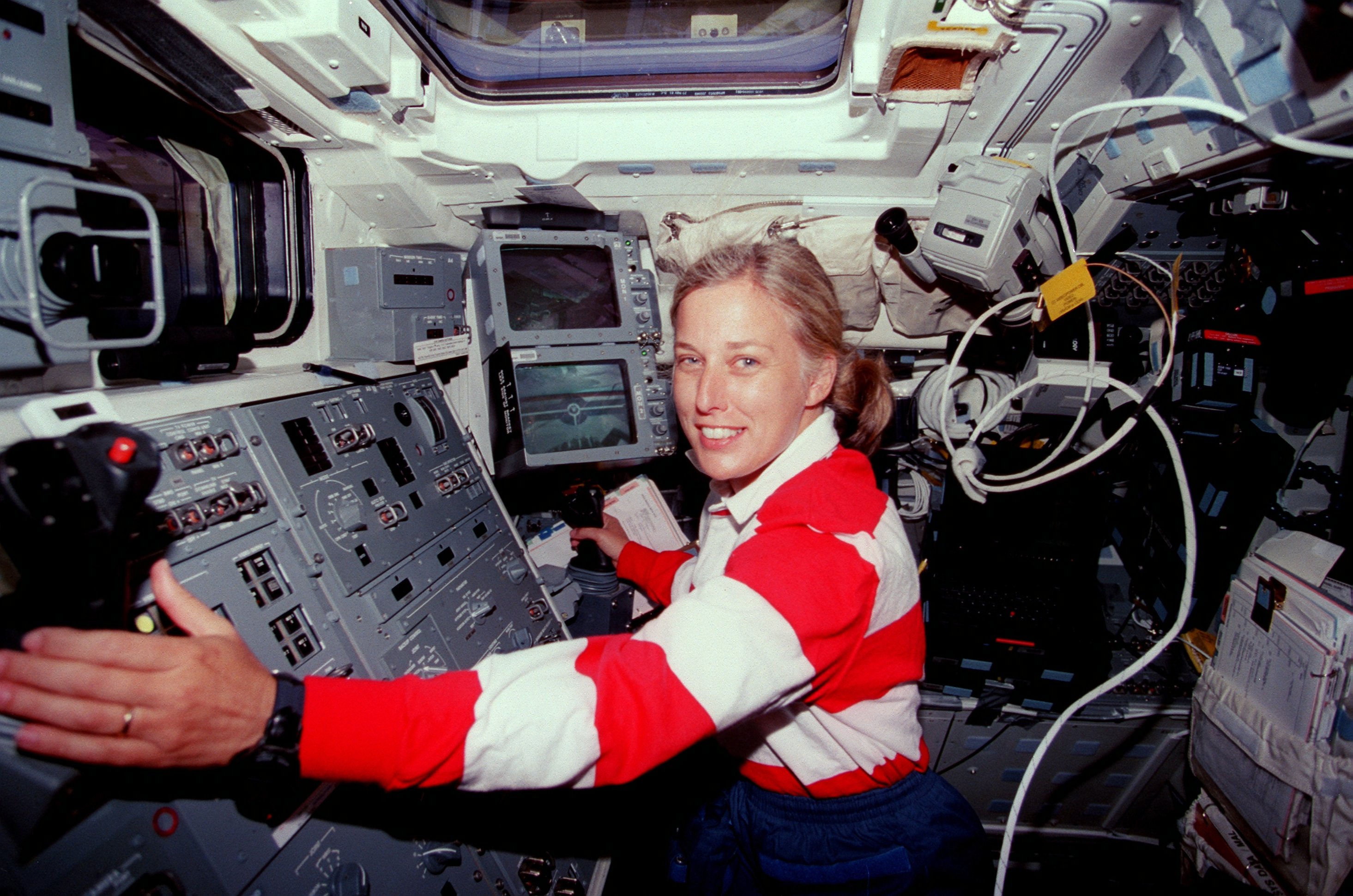 Image of Davis on the work station of a shuttle