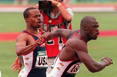 Derek Mills handing off baton