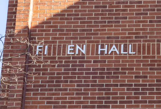 Side of the building with some of the letters removed from the name of the building