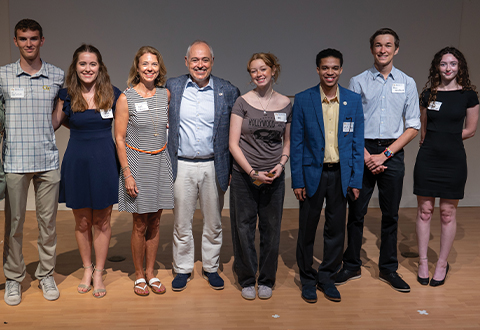 Students and alumni are pictured smiling with President Angel Cabrera and Dr. Beth Cabrera.