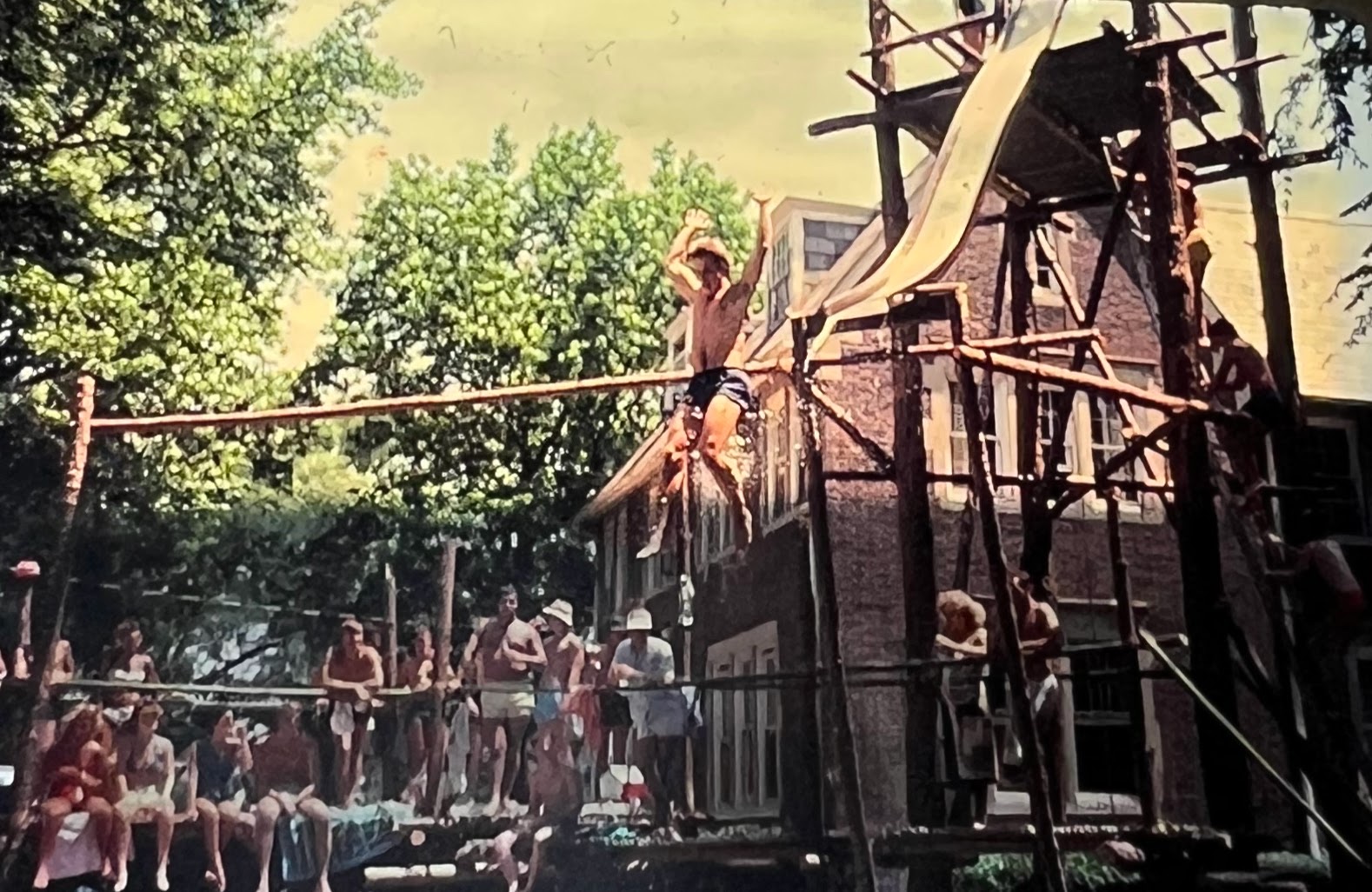 Guy jumping into a pool