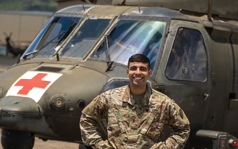 Mahdi Al-Husseini in front of a military helicopter
