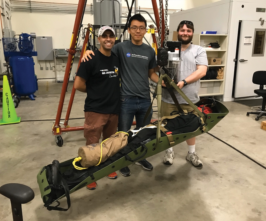 Three people in a photo with the medic military equipment