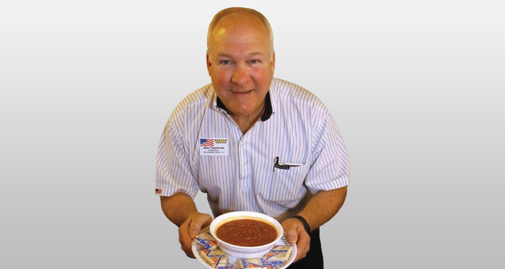 man holding a bowl of chilis