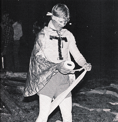 T man at a bonfire