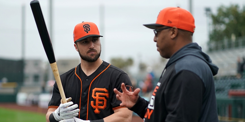 Joey Bart with a coach on the field