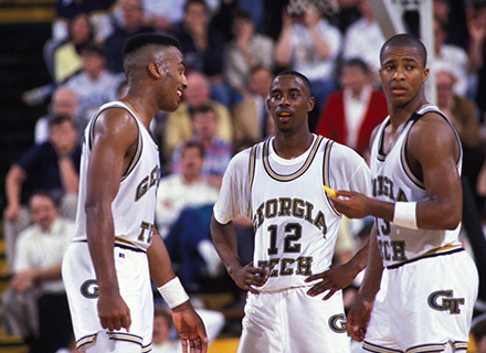 Three Tech basketball players on the court