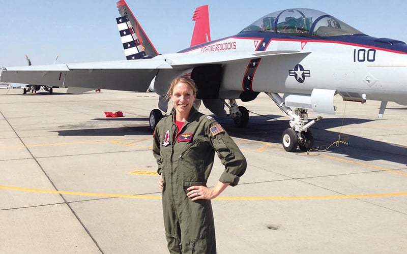 Jenny Moore standing in front of a fighter jet