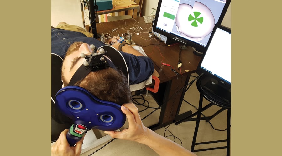 A participant attached to a machine which analyzes his movements.