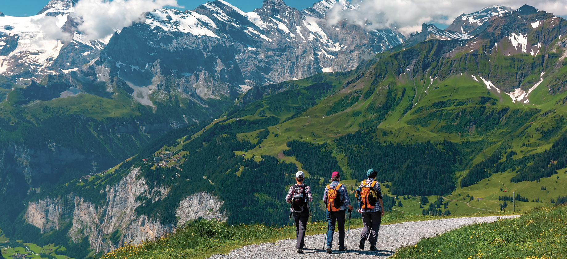 Three people walking in the alps